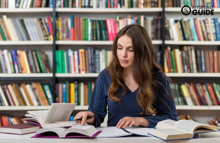 female student studying in university library
