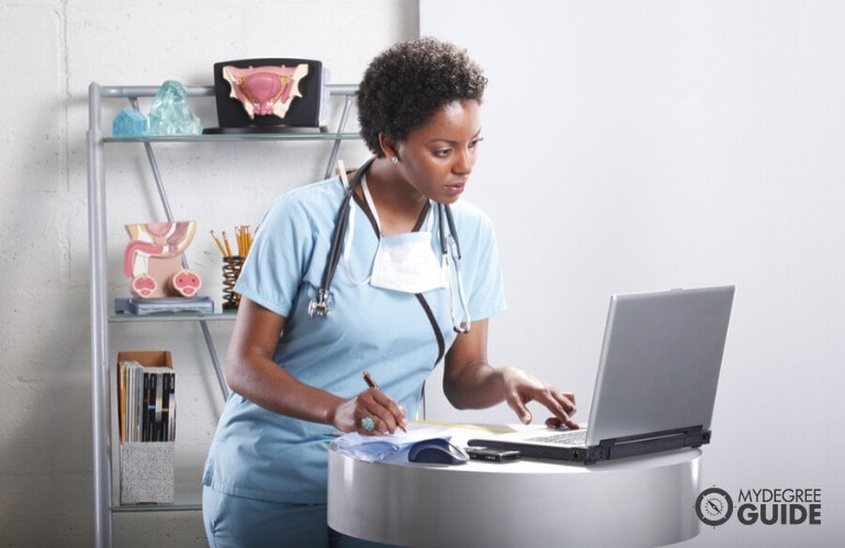 a nurse studying on her computer