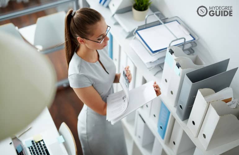 bookkeeper arranging documents in an office
