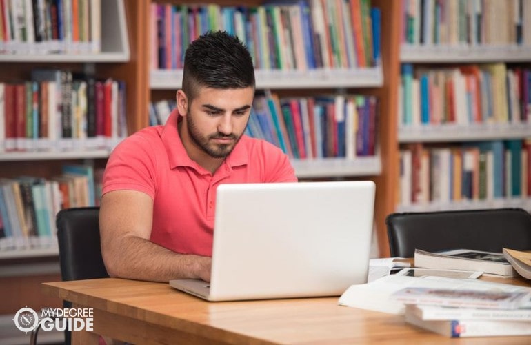 Social Work Degree student studying at a library