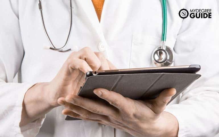 medical doctor with ipad searching for best info