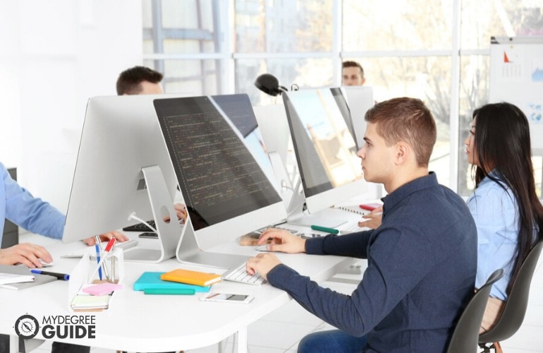 computer programmers working together in an office
