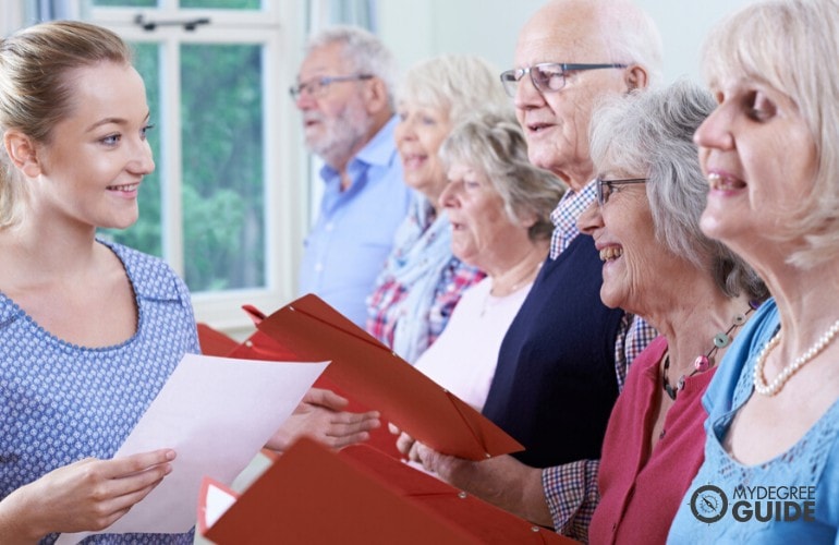 church music director directing a group of elderly people singing
