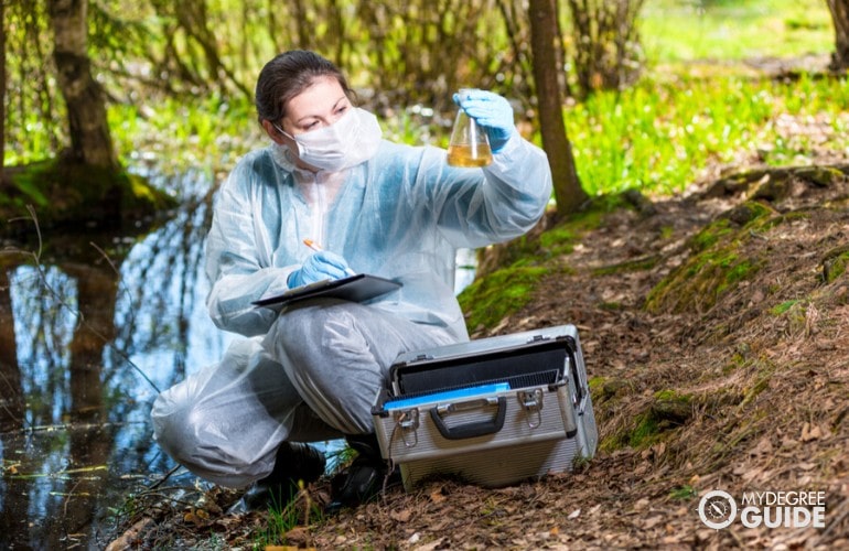 scientist checking water samples from a swamp
