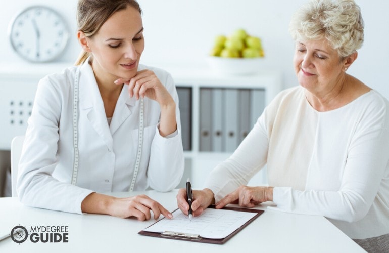 nutritionist with an elderly patient during consultation