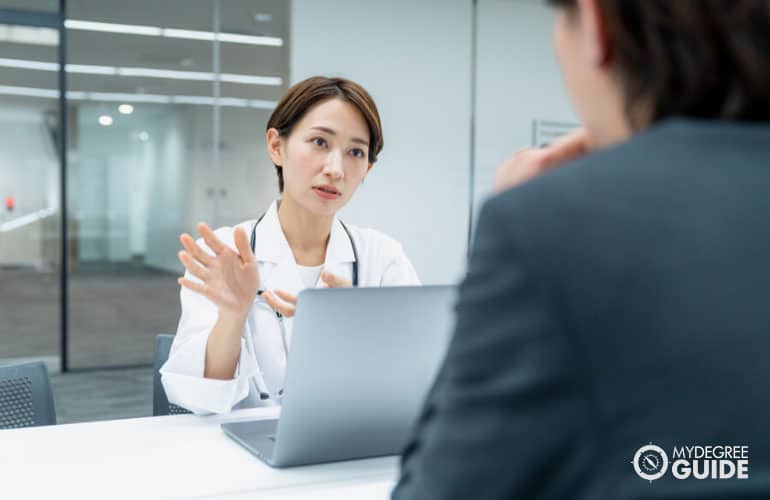 health consultant providing information to a company manager