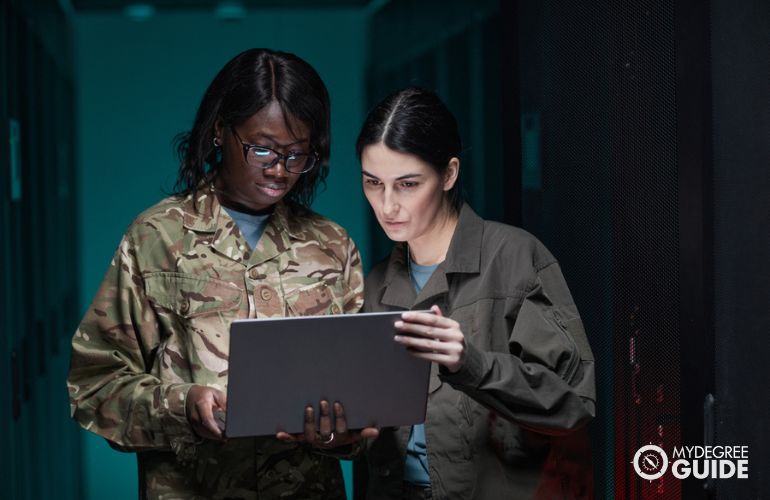 Information Security Analyst and an officer, looking at some data