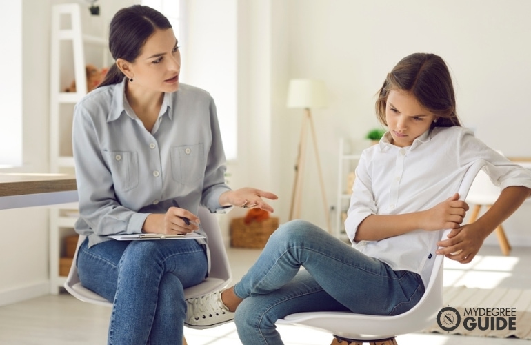 a licensed clinical psychologist counseling a child