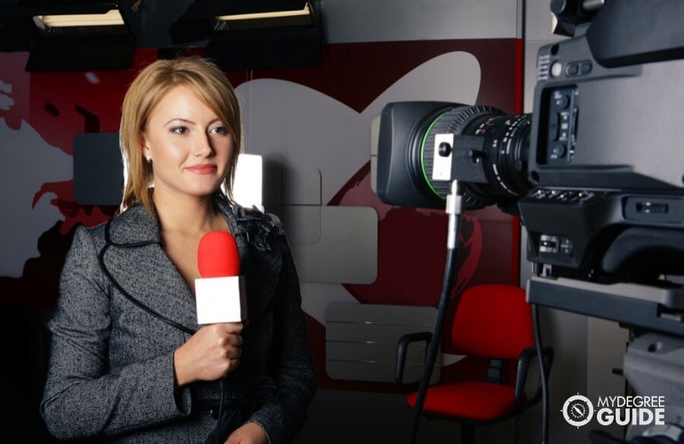 reporter preparing in front of a camera