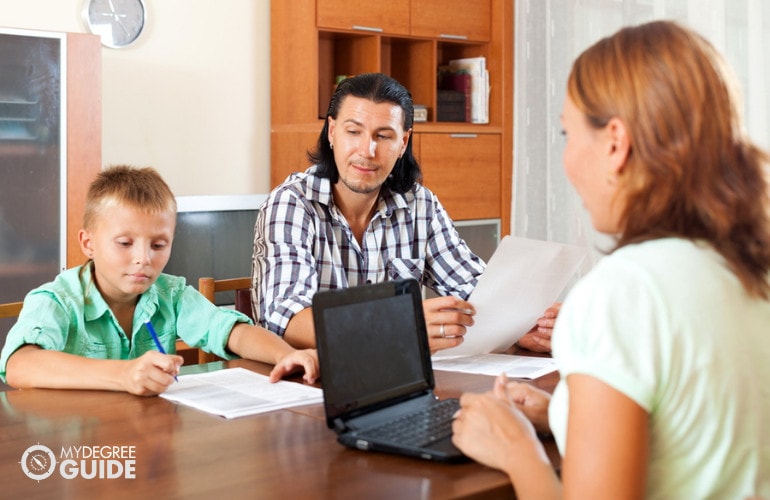 social service worker interviewing a father and his son