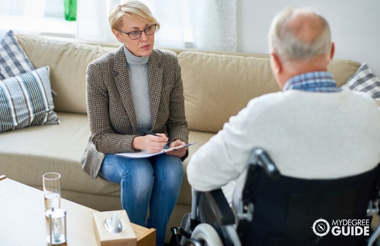 psychologist talking to an elderly patient