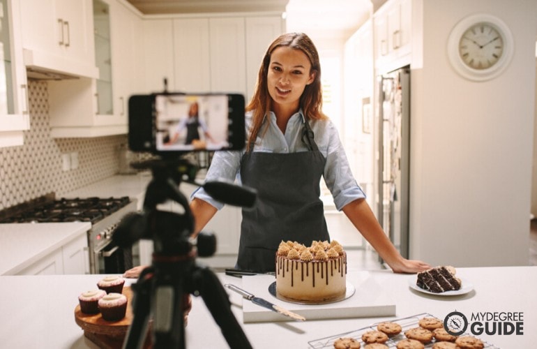 female baker vlogging herself to market her business