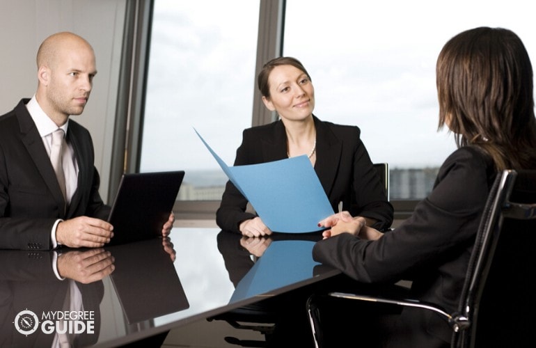 human resource managers interviewing a job applicant