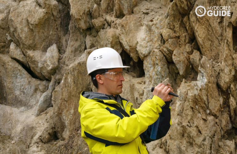 Geo scientist analyzing rock formations