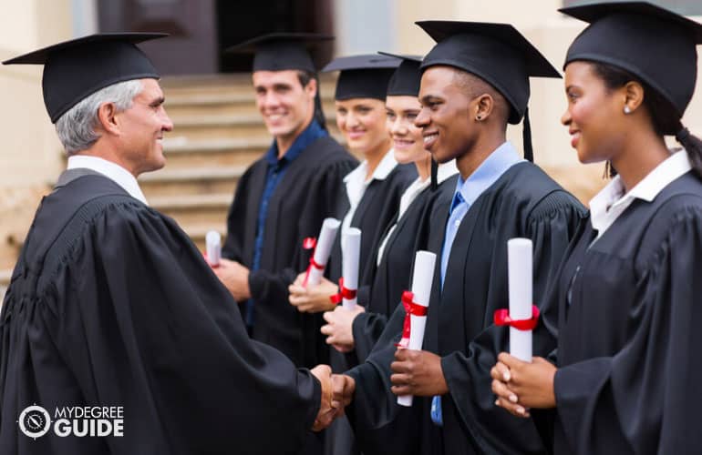master's degree graduates receiving their diploma
