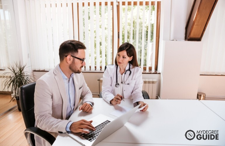 healthcare administrator meeting with a doctor