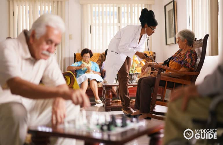 female doctor checking seniors at a nursing home