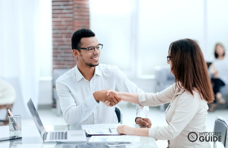 human resource manager shaking hands of a colleague
