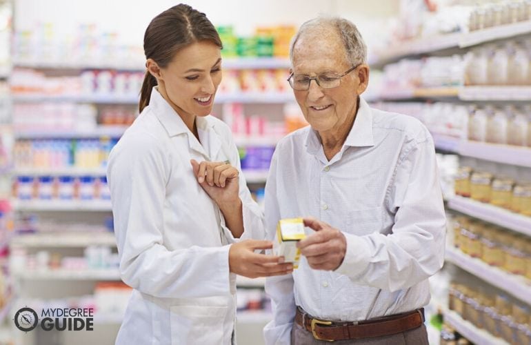 Pharmacist providing prescribed meds to an elderly customer