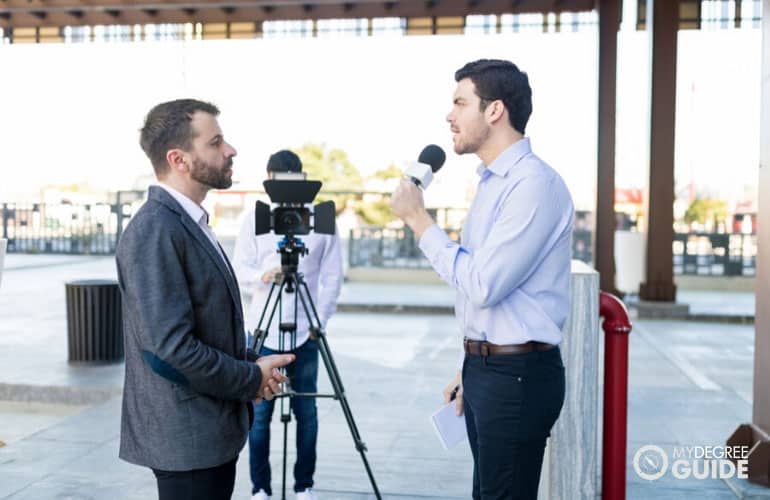 male journalist interviewing a businessman