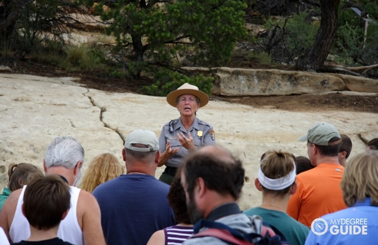 Park Ranger explaining rules to tourists when visiting the park