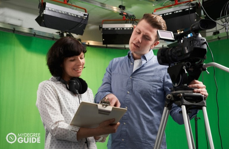 TV producer giving instruction to a camera man