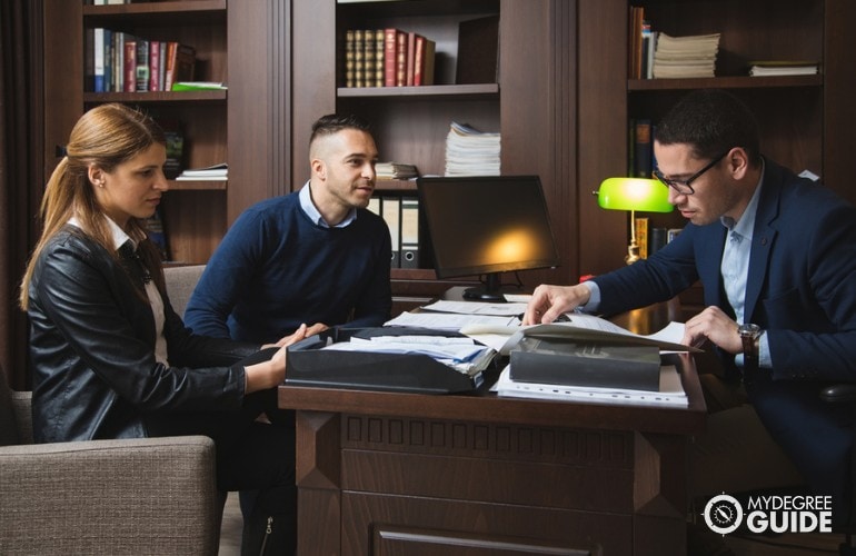 Lawyer meeting with clients in his office