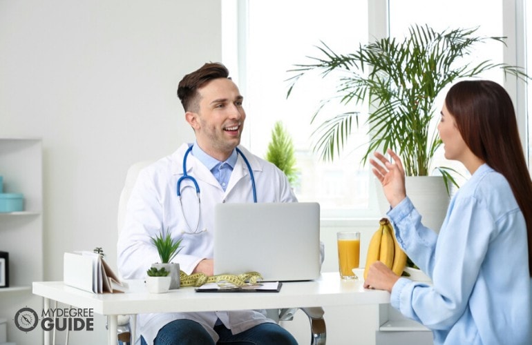 nutritionist talking to a client in his clinic 