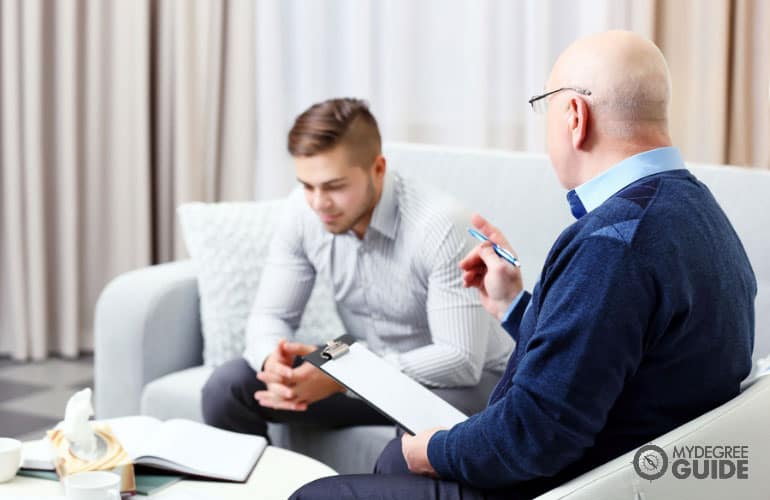 medical family therapist talking to a client with mental health illness