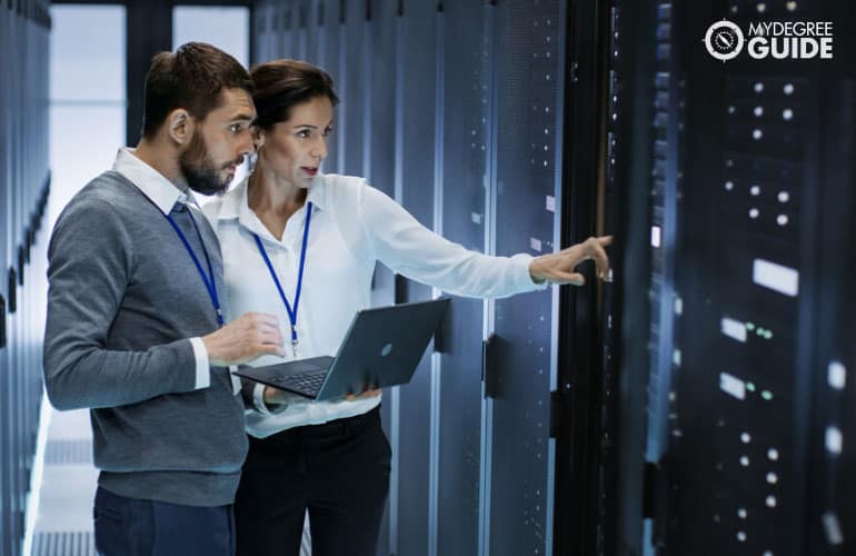 network administrator talking to a colleague in a database