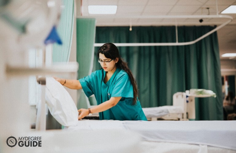 nurse fixing a hospital bed