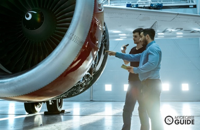 Aerospace Engineers checking the aircraft's engine