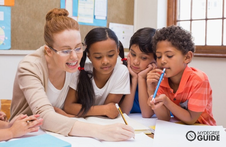 Elementary teacher teaching her students to write