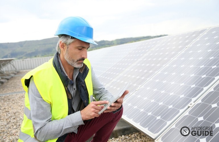 Environmental Engineer inspecting solar panels