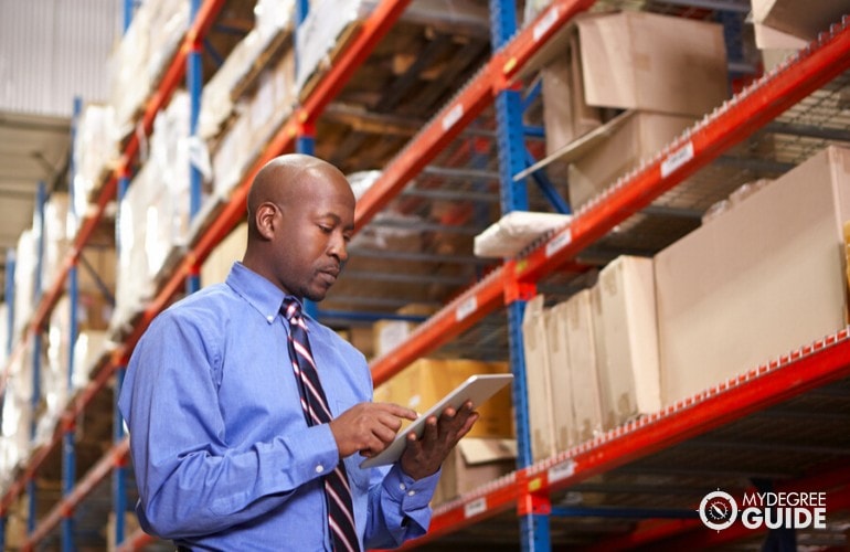 supply chain manager checking warehouse inventory