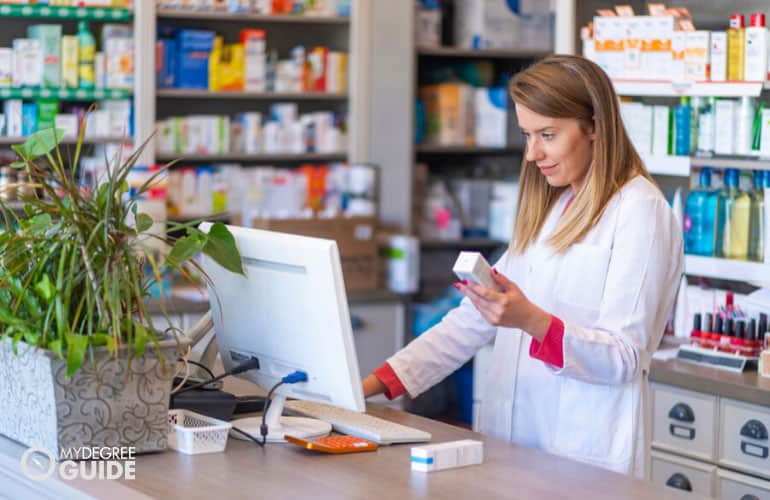 pharmacist checking a medicine on her computer