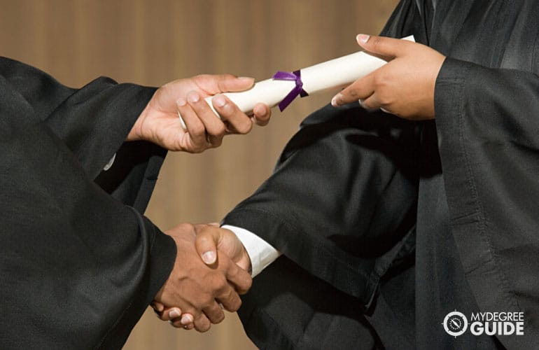 a person receiving a diploma at a graduation ceremony