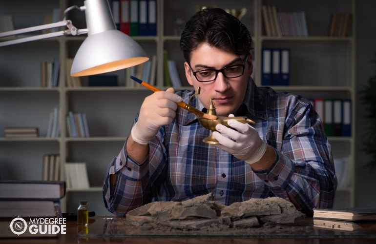 Anthropologist examining new found artifacts