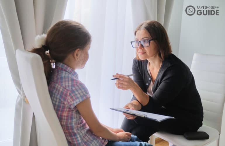 counselor talking to a female child