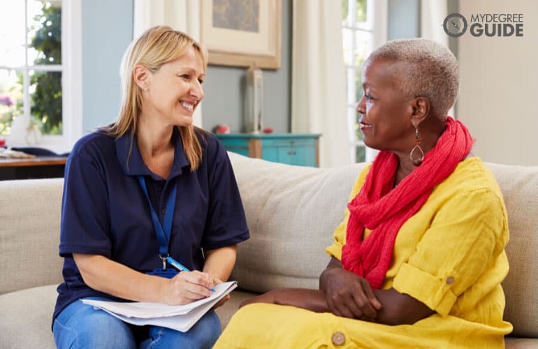 social worker talking to an elderly woman