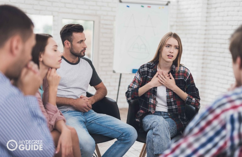 female sharing her problems during group therapy session