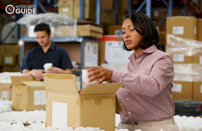 female manager checking goods at a warehouse