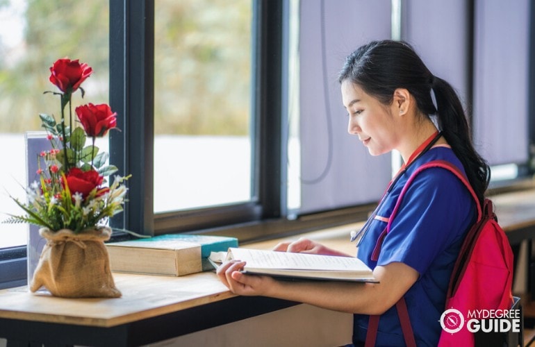 nurse studying a book