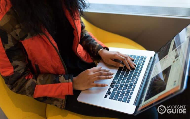 woman searching for scholarships on laptop
